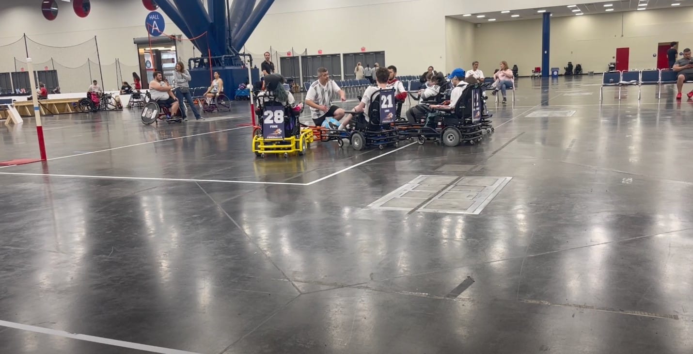 A group of people in wheelchairs
Description automatically generated