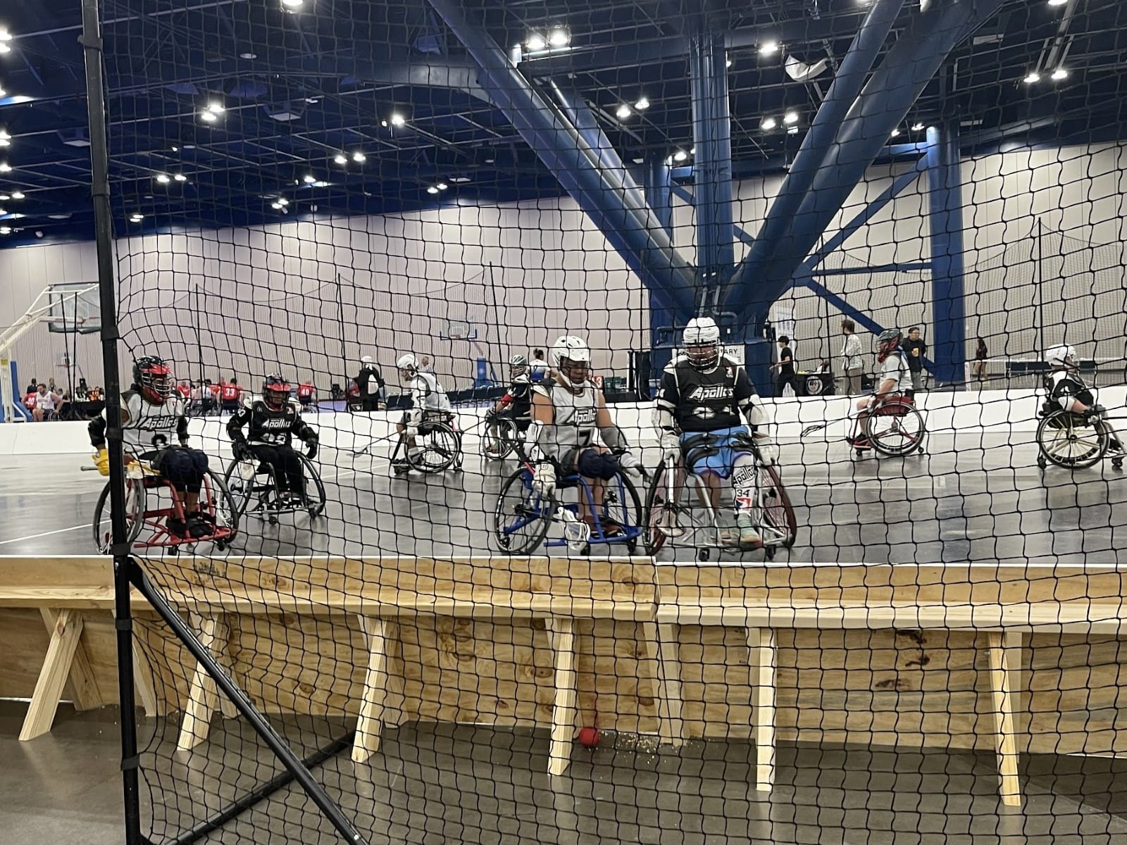 A group of people in wheelchairs in a gym
Description automatically generated